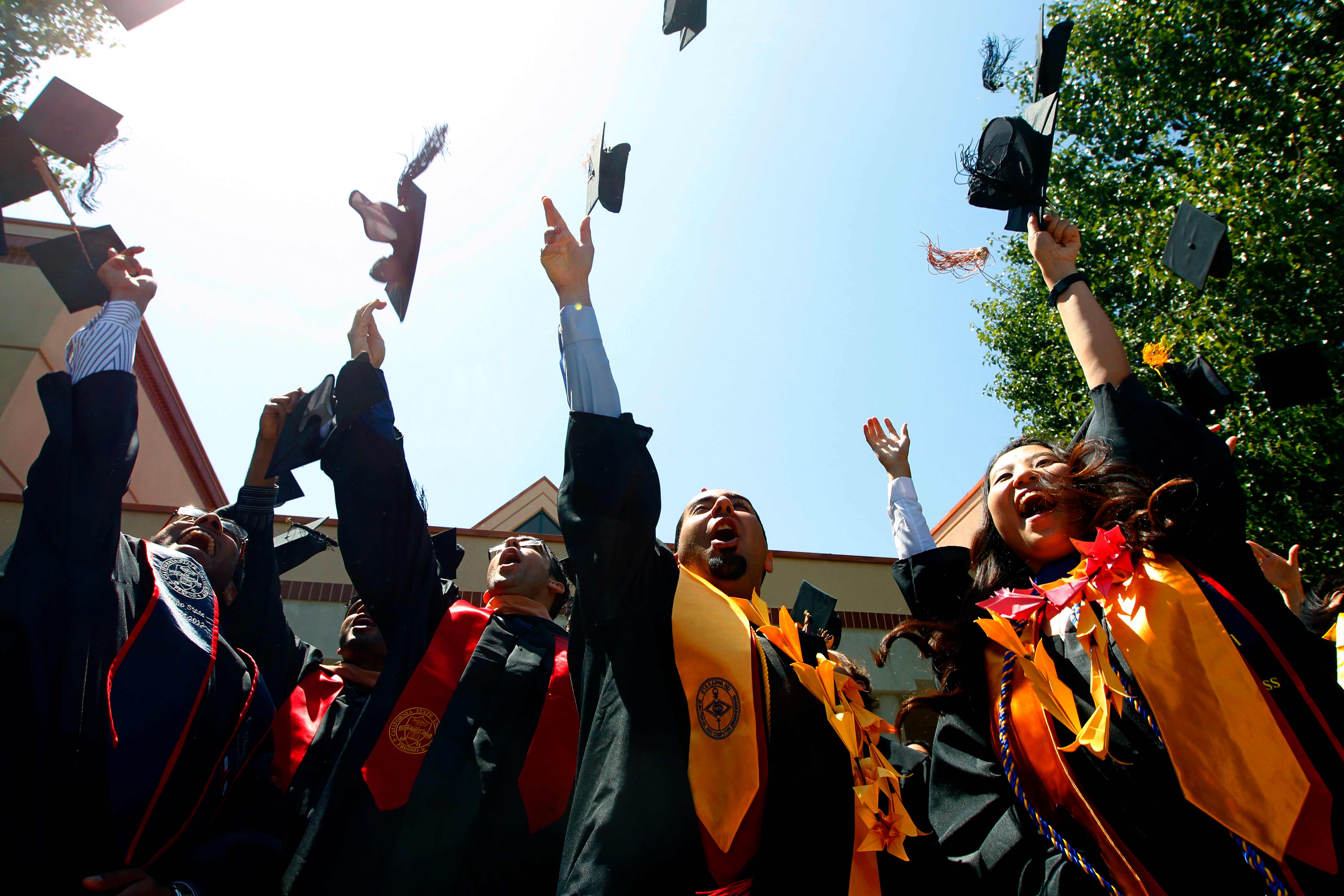 Graduates tossing their caps in the air